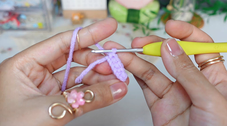 Crochet stitches forming flower base