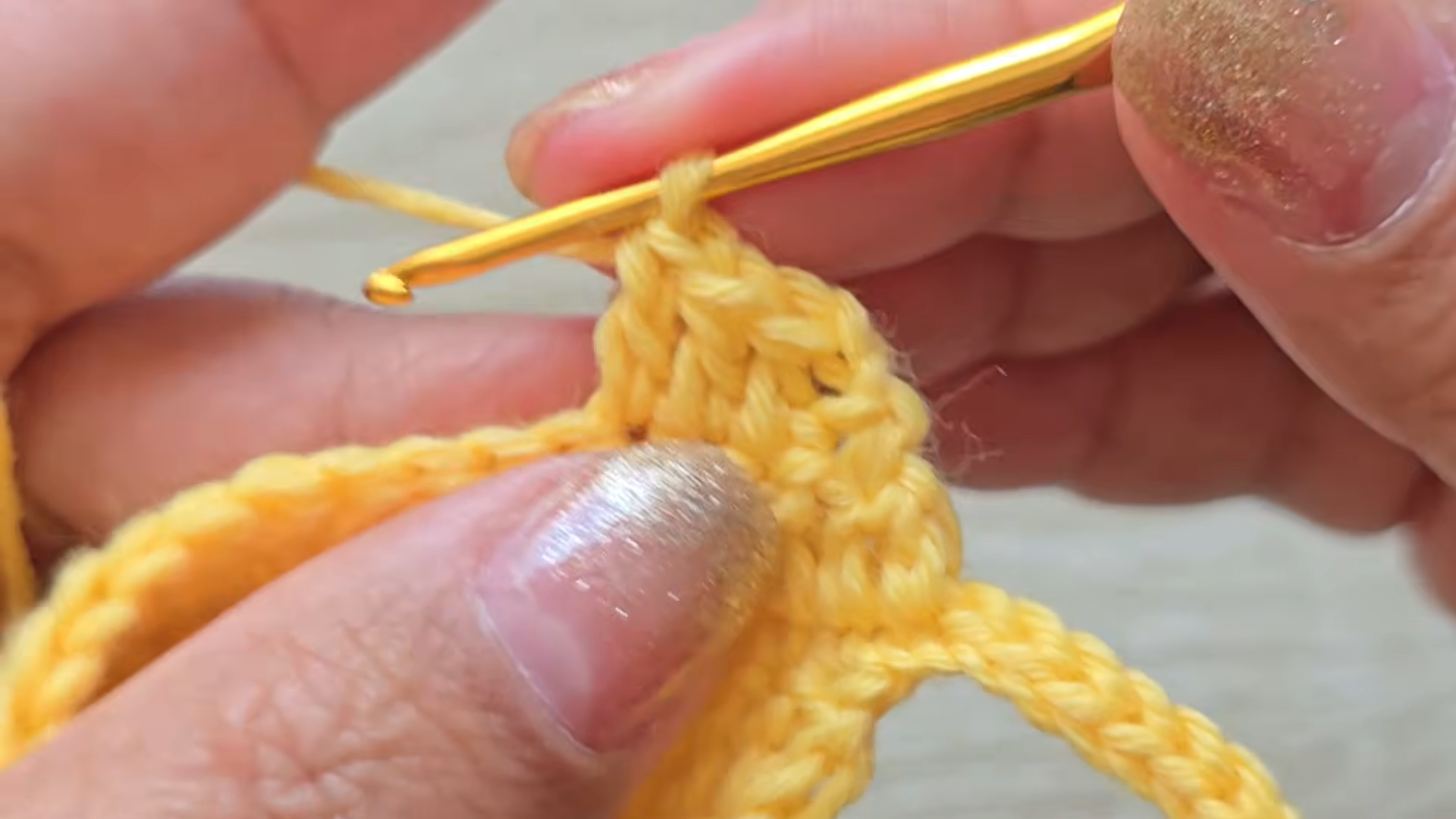 Crochet stitches with gold hook close-up