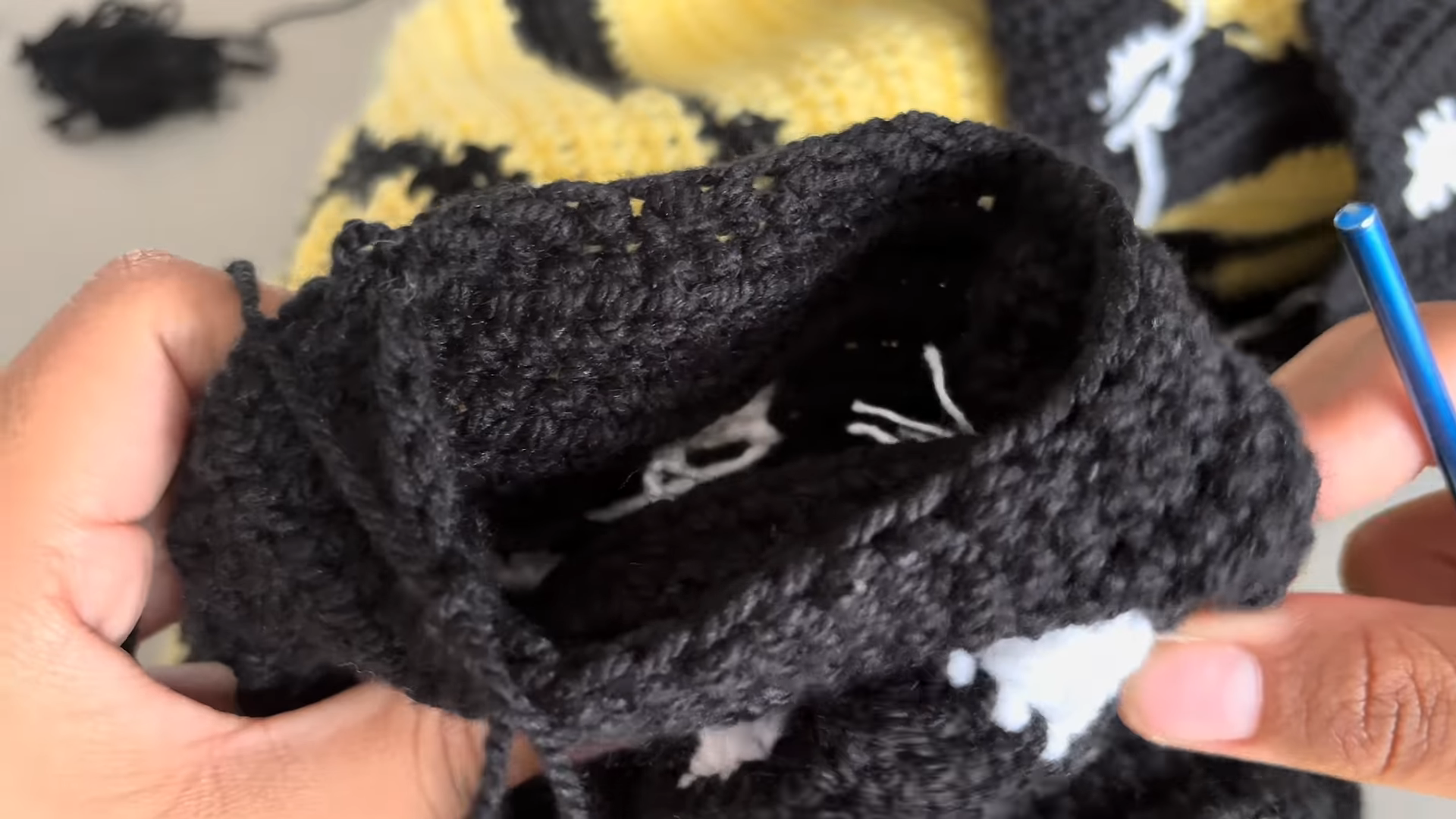 Folded black crochet cardigan piece