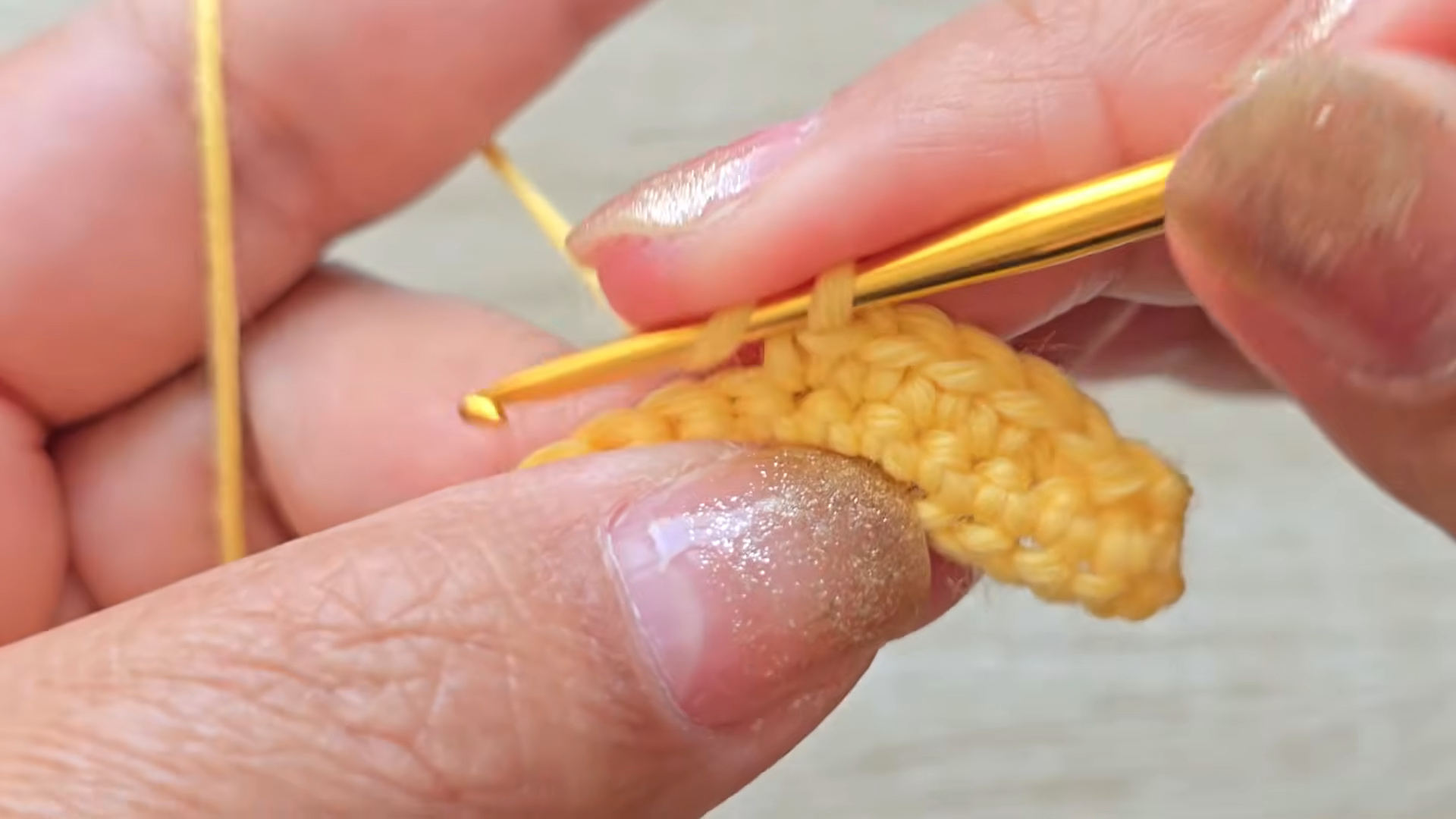 Single crochet row in yellow yarn