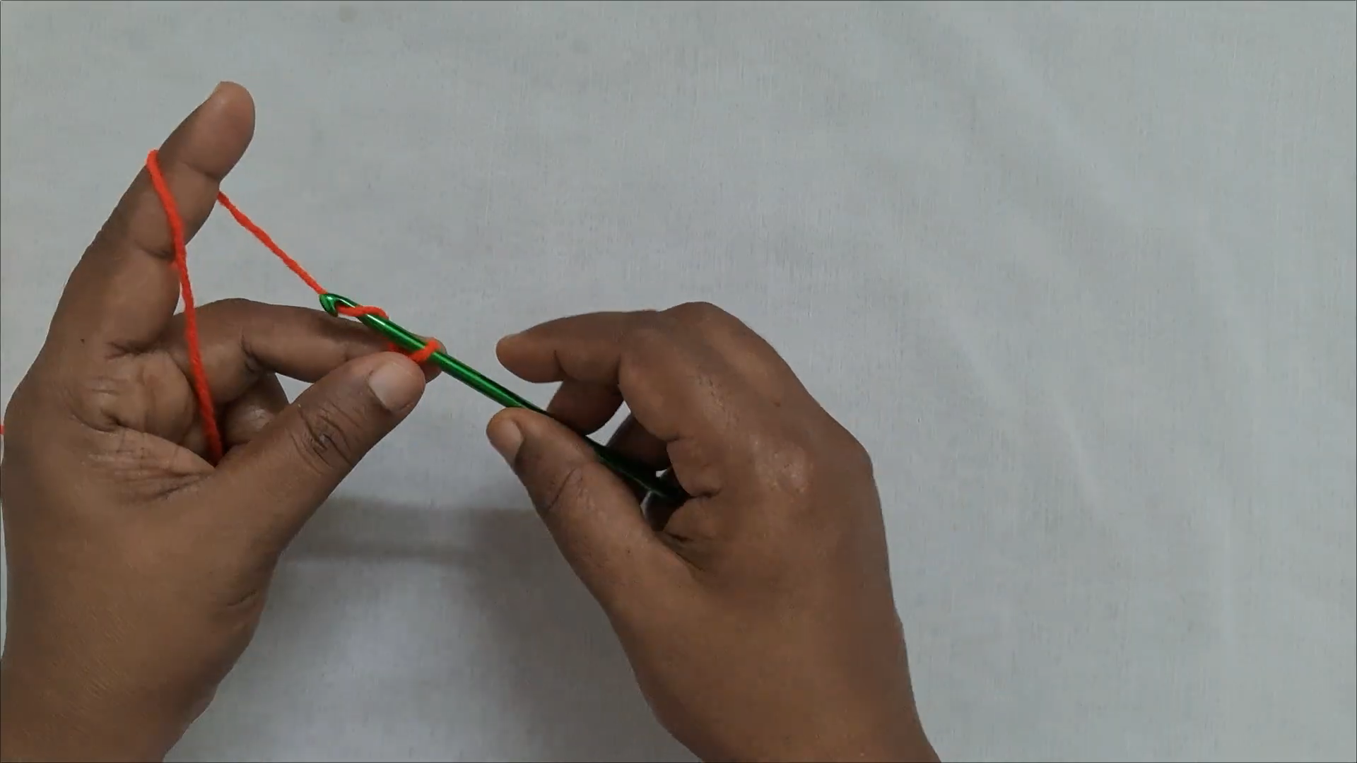 Slip knot with orange yarn for crochet car purse