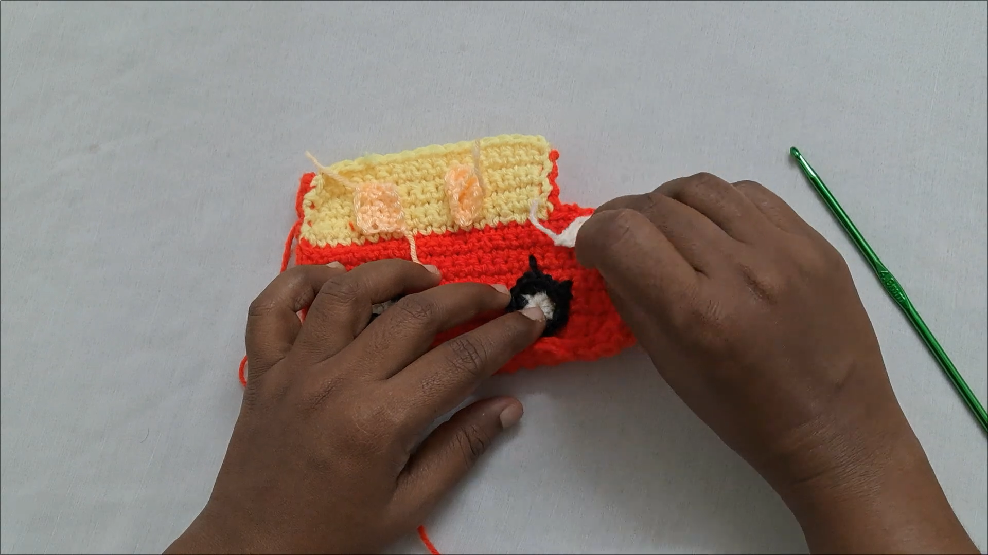 Wheels attached to crochet car mini purse