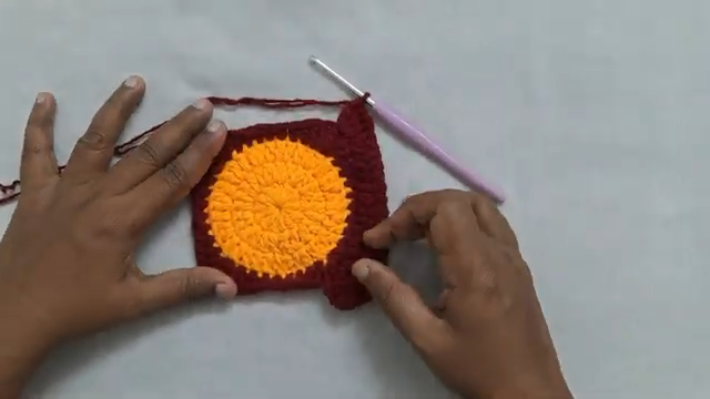 Yellow and maroon crochet circle motif