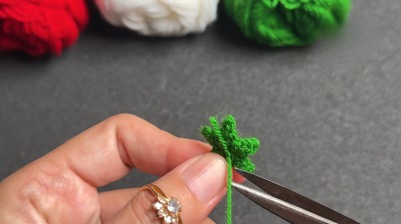Attaching crochet stars along white bracelet band