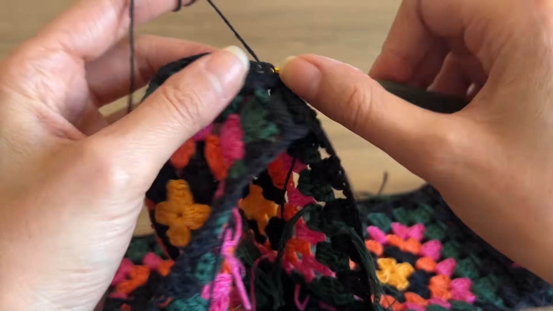 Black scalloped hem on a crochet granny square skirt