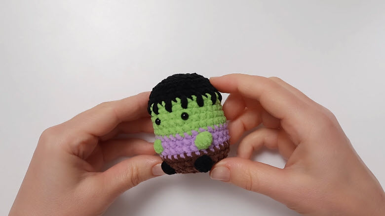 Finished crochet Frankenstein keychain with black fringe