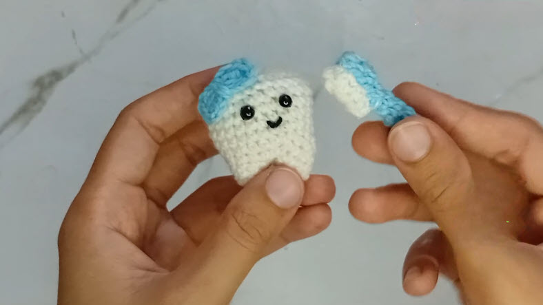 Finished crochet tooth and toothbrush keychain pair
