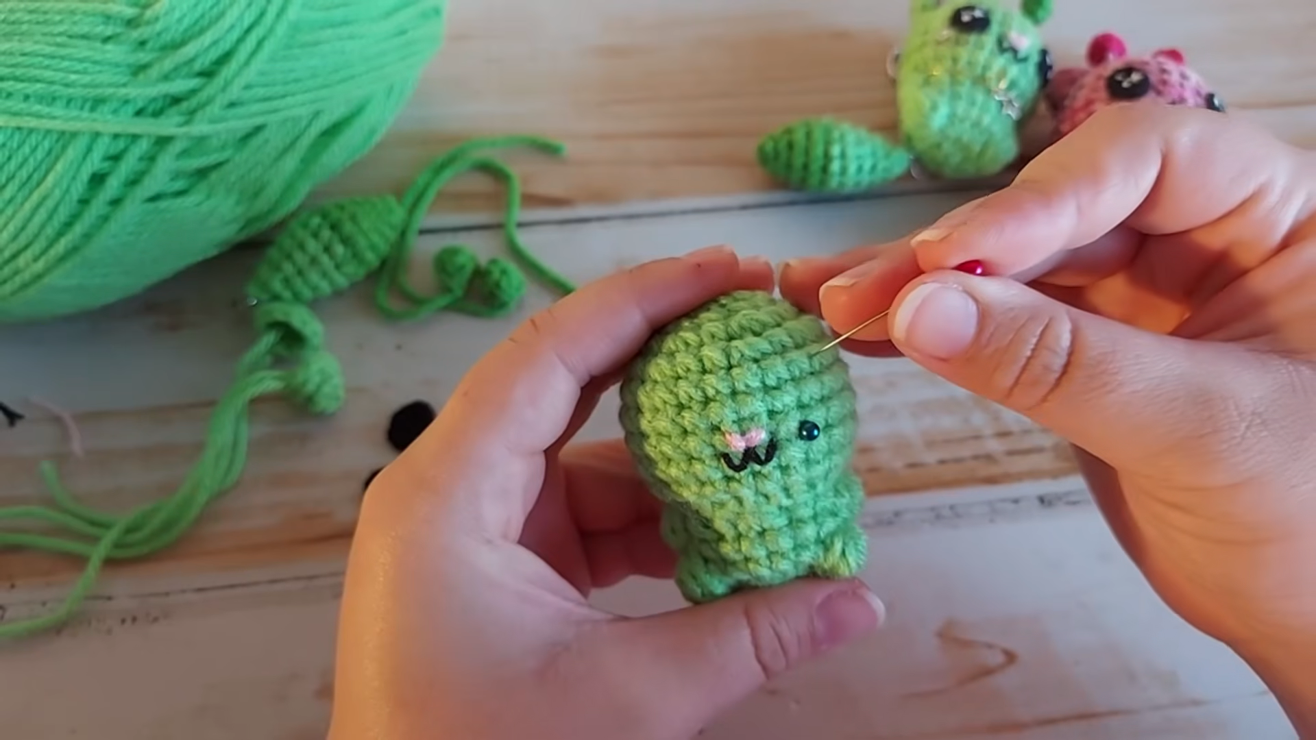 Finished green alien cat with embroidered face detail