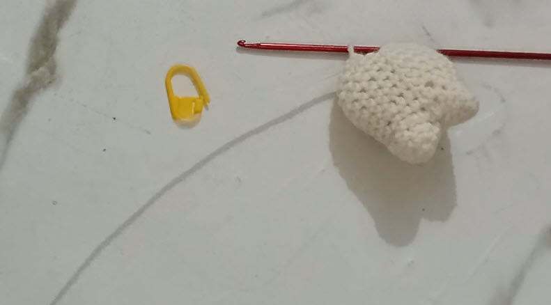Finished white crochet tooth shape close-up