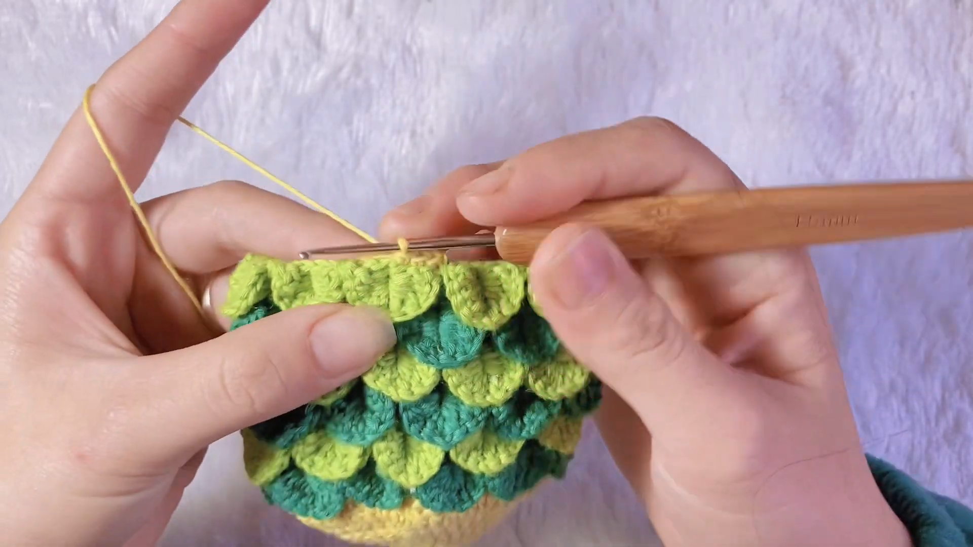 Green scalloped edging around the open yellow fish bag