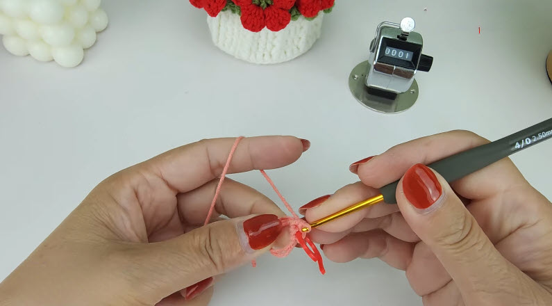 Peach magic ring R1 6sc, stitch counter and crochet hook shown.