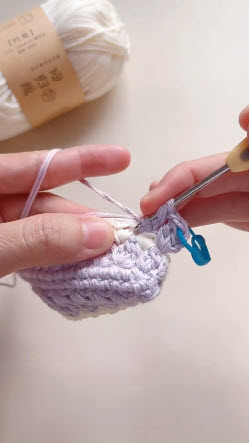 Purple textured stitches on the crochet mini card holder body