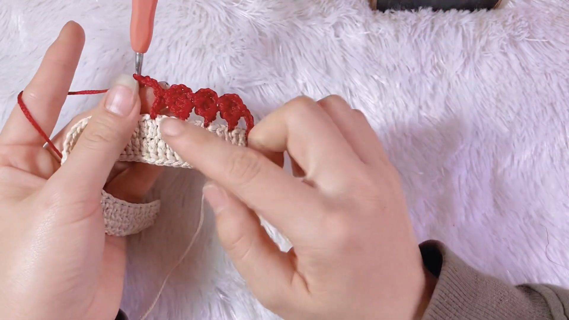 Red popcorn stitch border forming along the purse rim