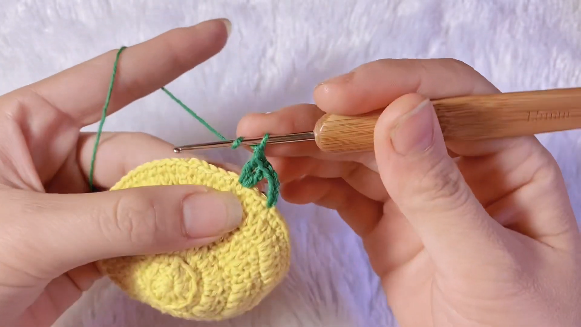 Rounded yellow crochet body taking shape for fish purse