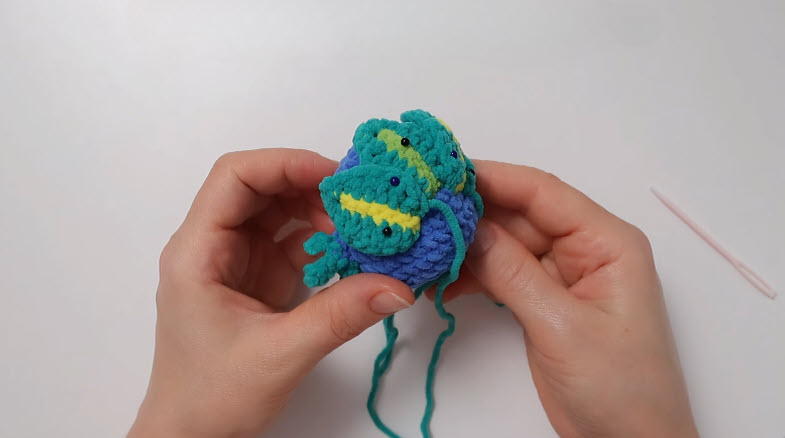Sewing crocheted tail feathers into fanned shape