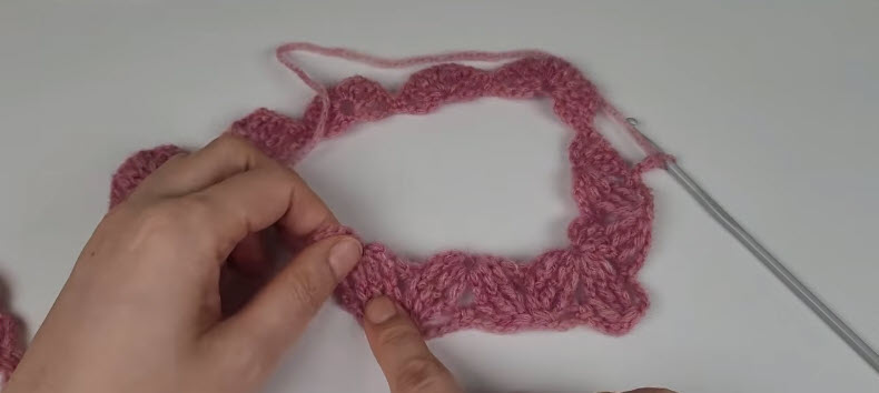 Shell stitch panel taking shape in pink yarn for the cardigan