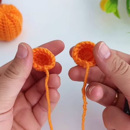 Two small orange crochet cups made for the pumpkin eyes