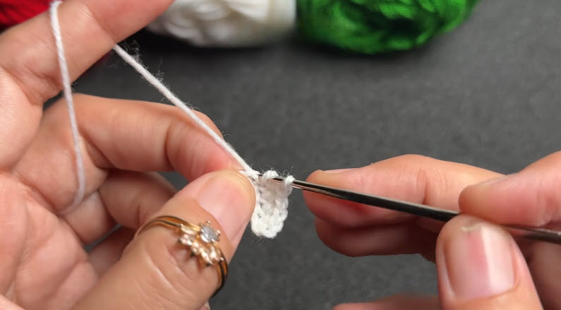White crochet chain forming bracelet base strand