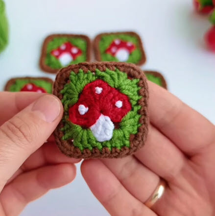 White dots on a crochet mushroom keychain pouch square