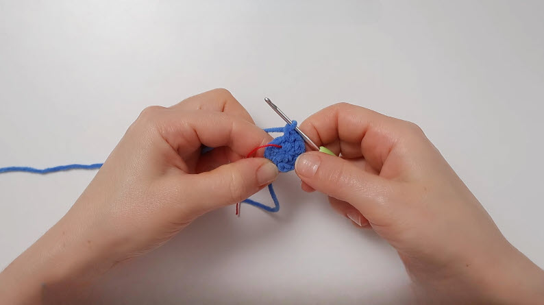 Working six increase stitches on peacock round two