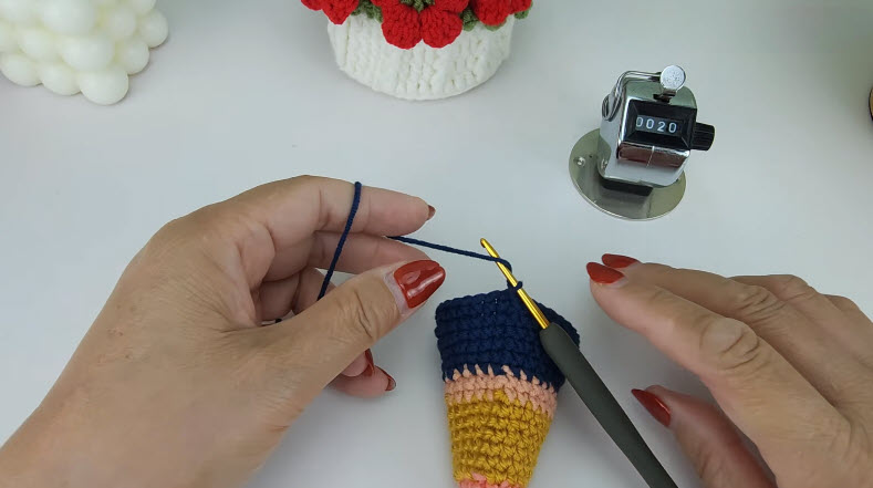 avy blue crochet cone top R18-R20 round, cone shows peach-mustard-navy layers.