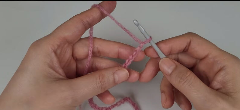 tarting foundation chain in pink yarn for the double-sided cardigan
