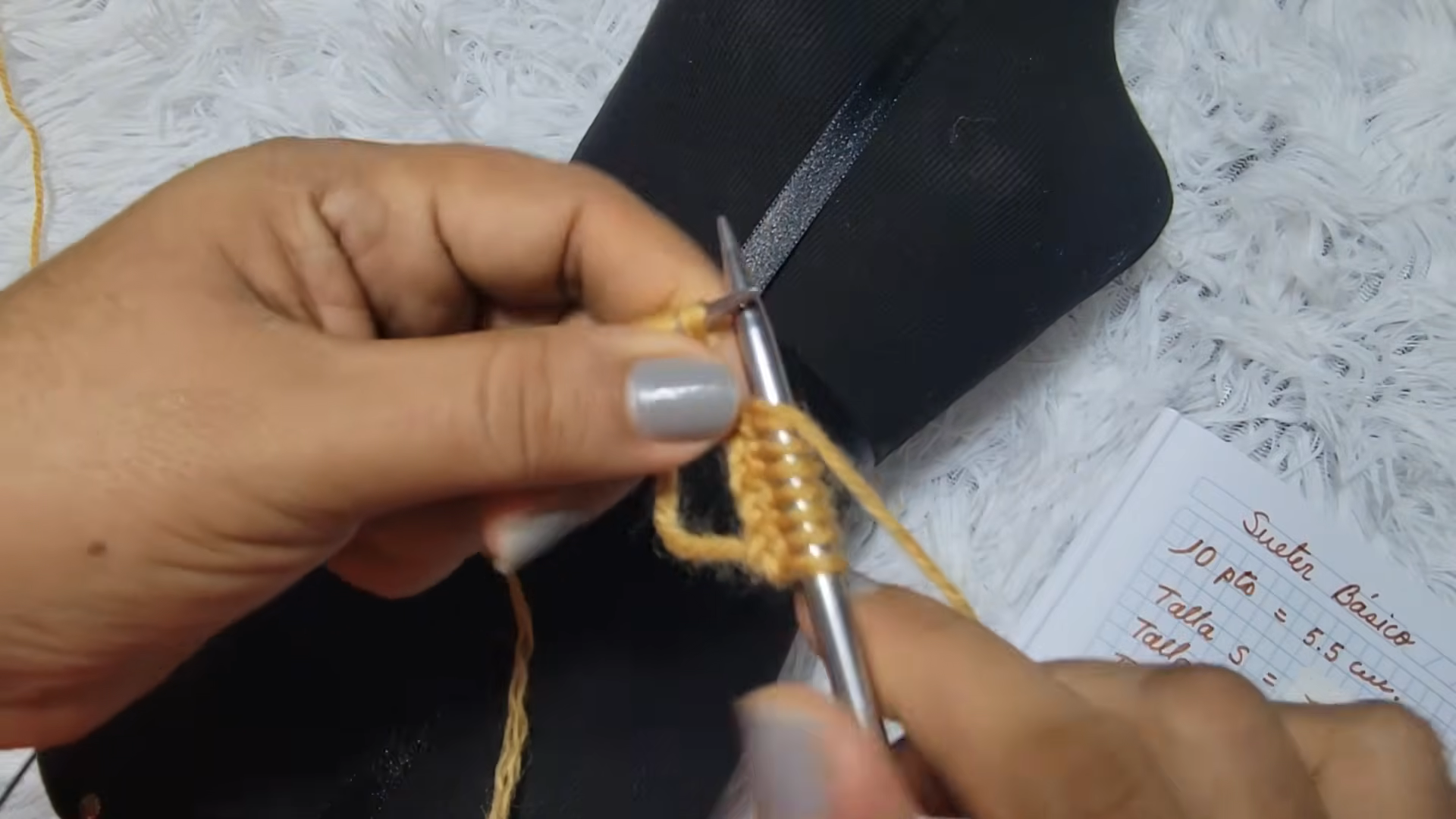 Casting on mustard yarn onto knitting needles.