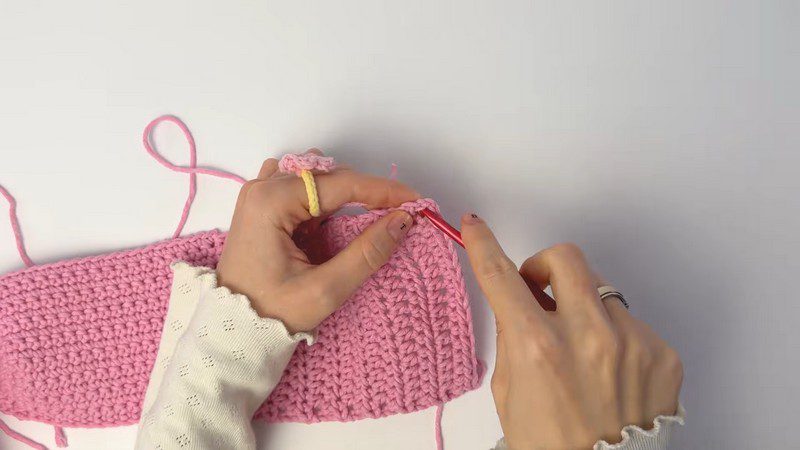 Crocheting along the panel edge to shape the corner.
