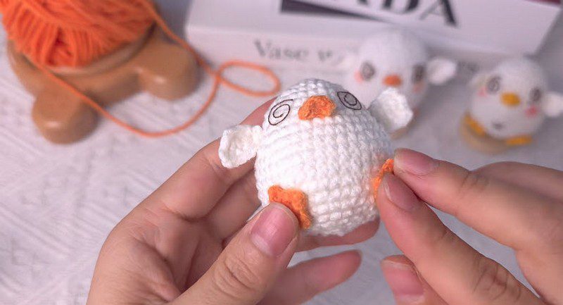 Finished white chick with orange beak and feet.
