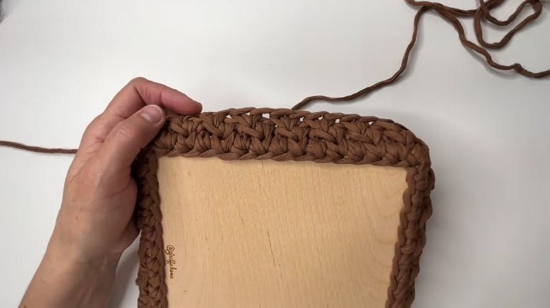 Tight rows of brown stitches building up around the base.