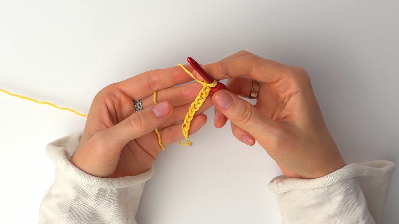 Yellow cotton starting chain worked with a red hook.